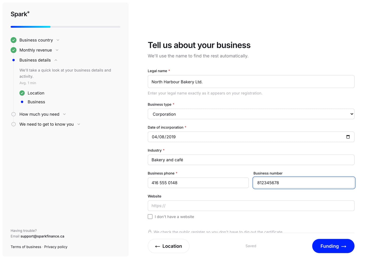 A wizard step with business details filled in. Between the Back and Next buttons at the bottom, the word Saved.